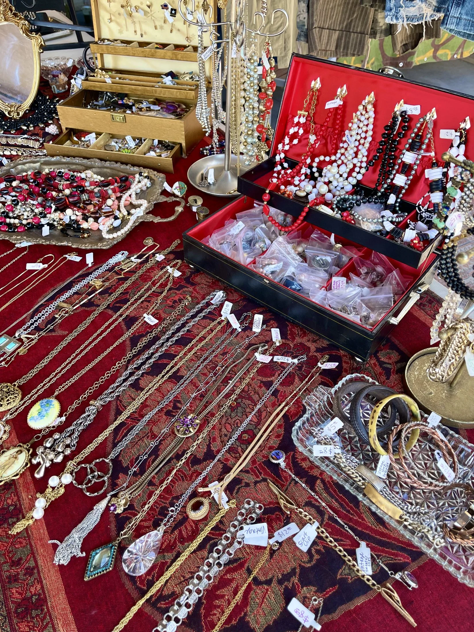 Vintage jewelry and accessories displayed at a market booth