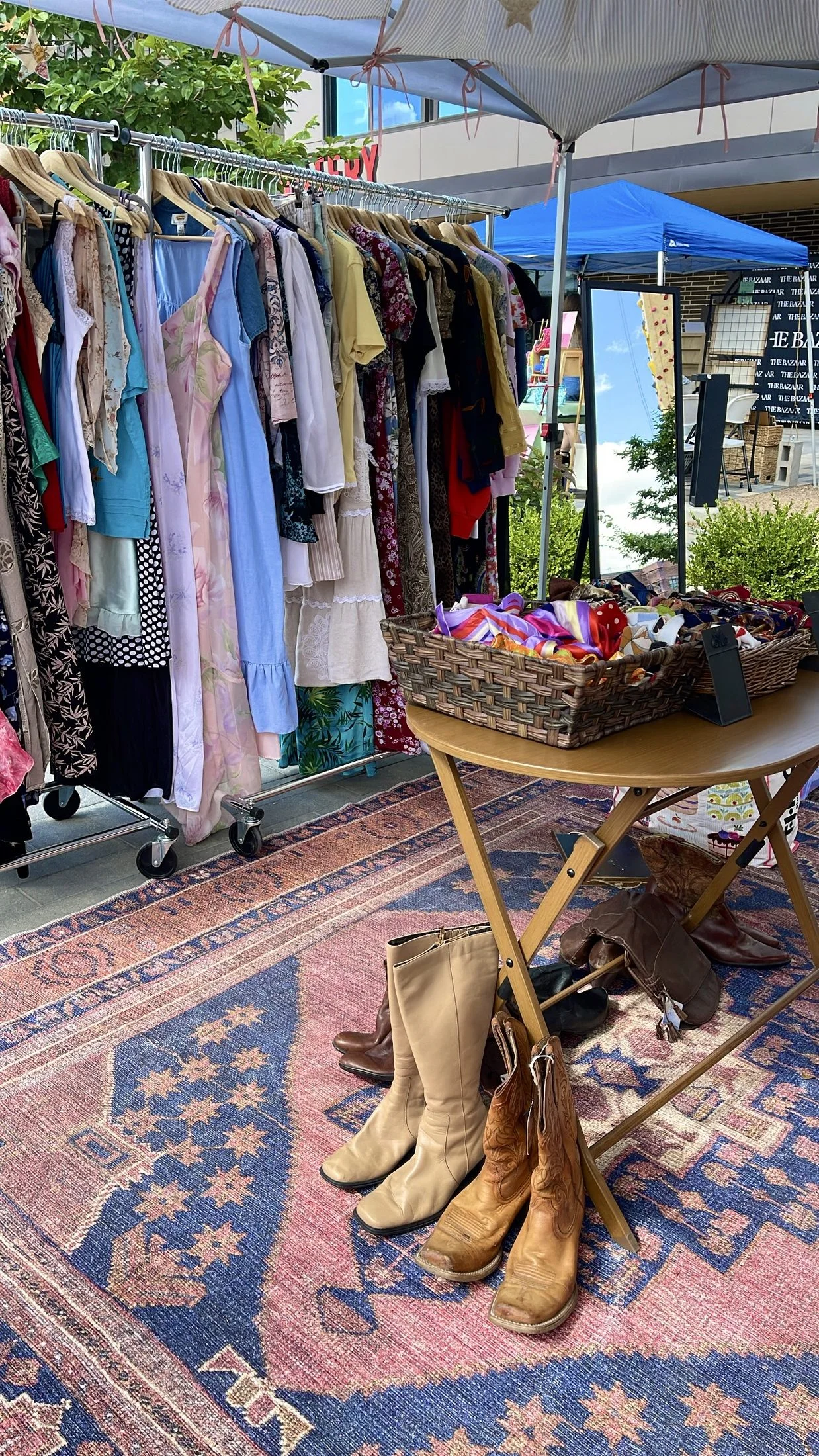 Vintage clothing booth with racks, accessories, and footwear